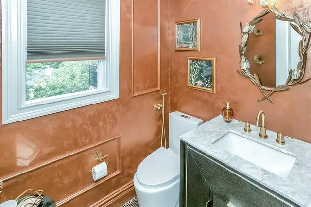a bedroom with a bed chandelier and a window