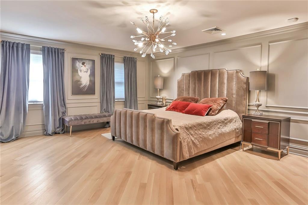 433 New Rochelle Road Bronxville, NY 10708 - Photo 19 of 41 a bedroom with a bed chandelier and a window
