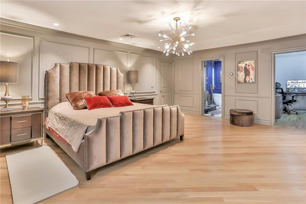 433 New Rochelle Road Bronxville, NY 10708 - Photo 20 of 41 a large bed sitting in a room next to a chandelier