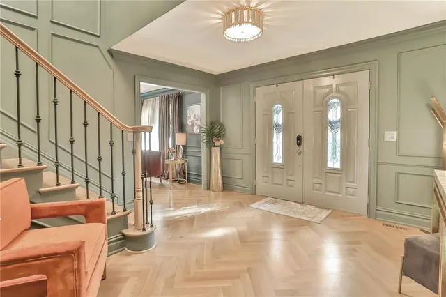a view of an entryway with wooden floor and mirror