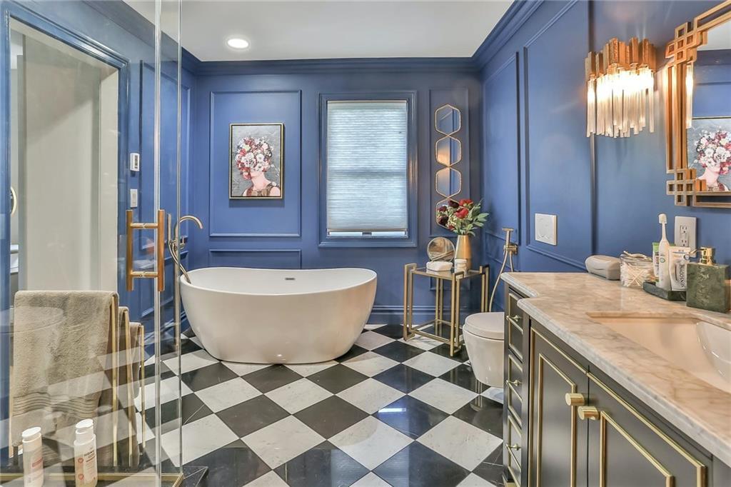433 New Rochelle Road Bronxville, NY 10708 - Photo 21 of 41 a spacious bathroom with a granite countertop sink and a mirror