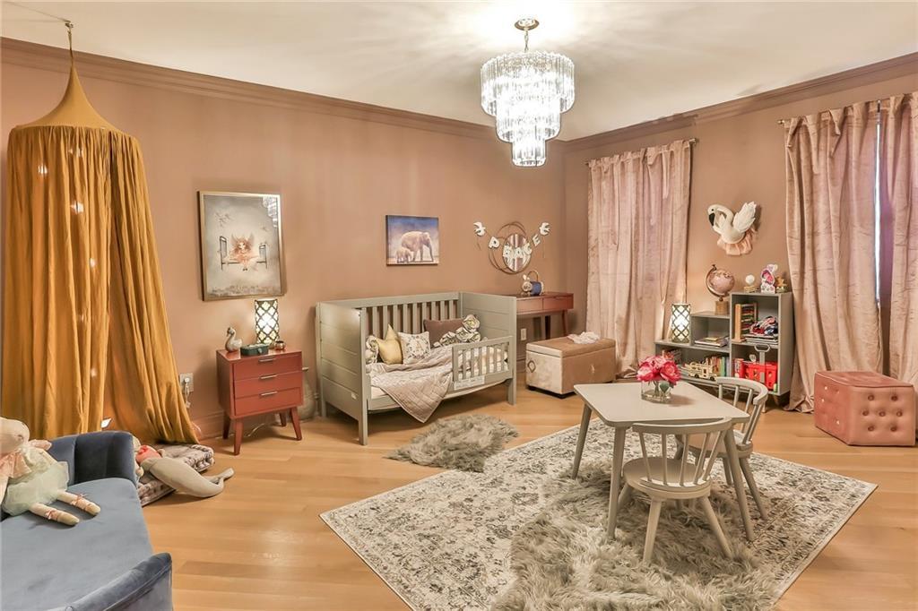 433 New Rochelle Road Bronxville, NY 10708 - Photo 24 of 41 a living room with furniture and a chandelier