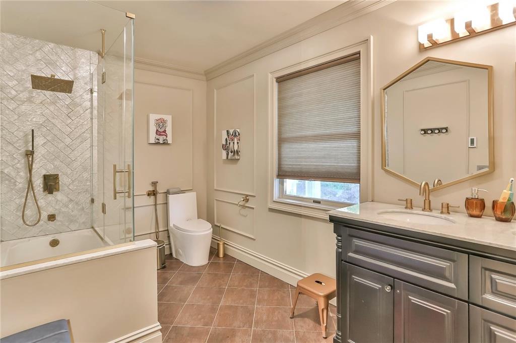 433 New Rochelle Road Bronxville, NY 10708 - Photo 25 of 41 a bathroom with a sink a toilet and shower