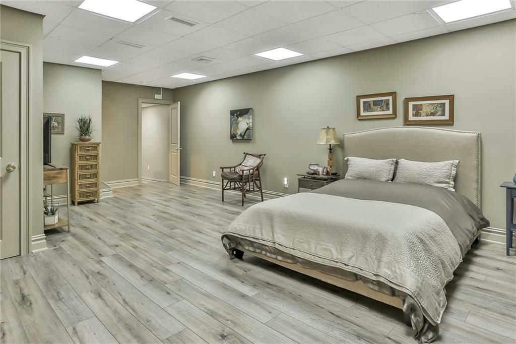 433 New Rochelle Road Bronxville, NY 10708 - Photo 28 of 41 a bedroom with a large bed and a wooden floor