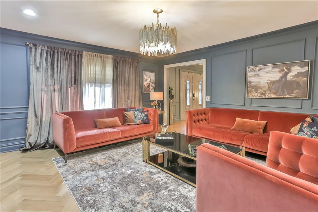 433 New Rochelle Road Bronxville, NY 10708 - Photo 4 of 41 a living room with furniture and a chandelier