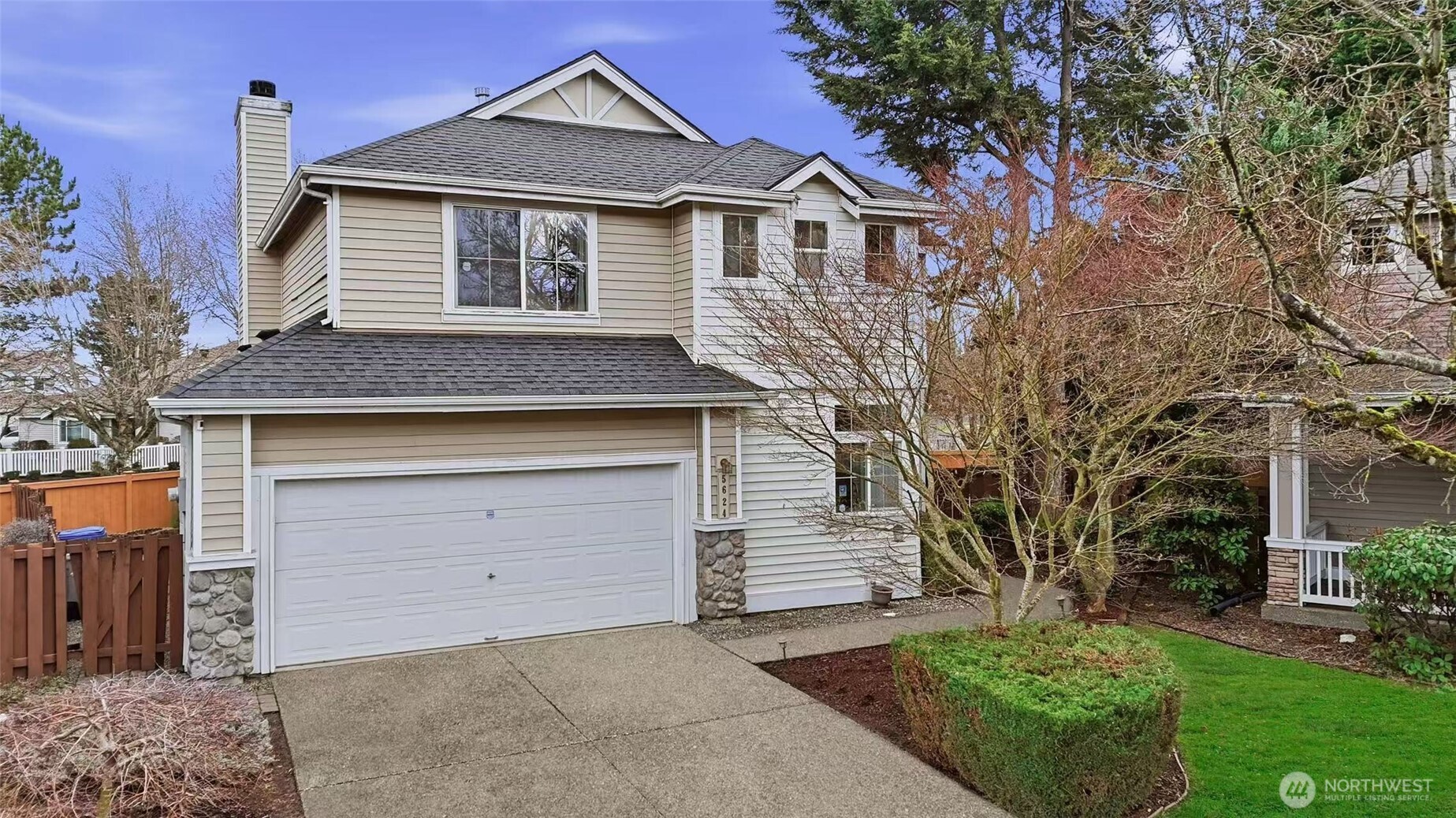 5624 South 233rd Street, Unit 41 Kent, WA 98032 - Photo 1 of 37 a front view of a house with a yard and garage