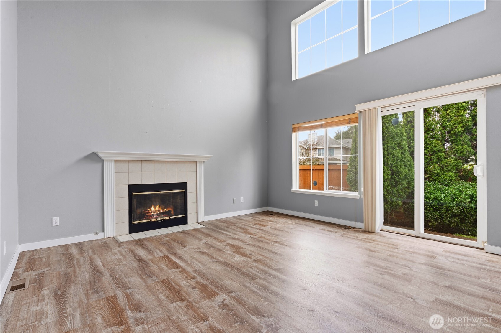 5624 South 233rd Street, Unit 41 Kent, WA 98032 - Photo 11 of 37 an empty room with large windows and a fireplace