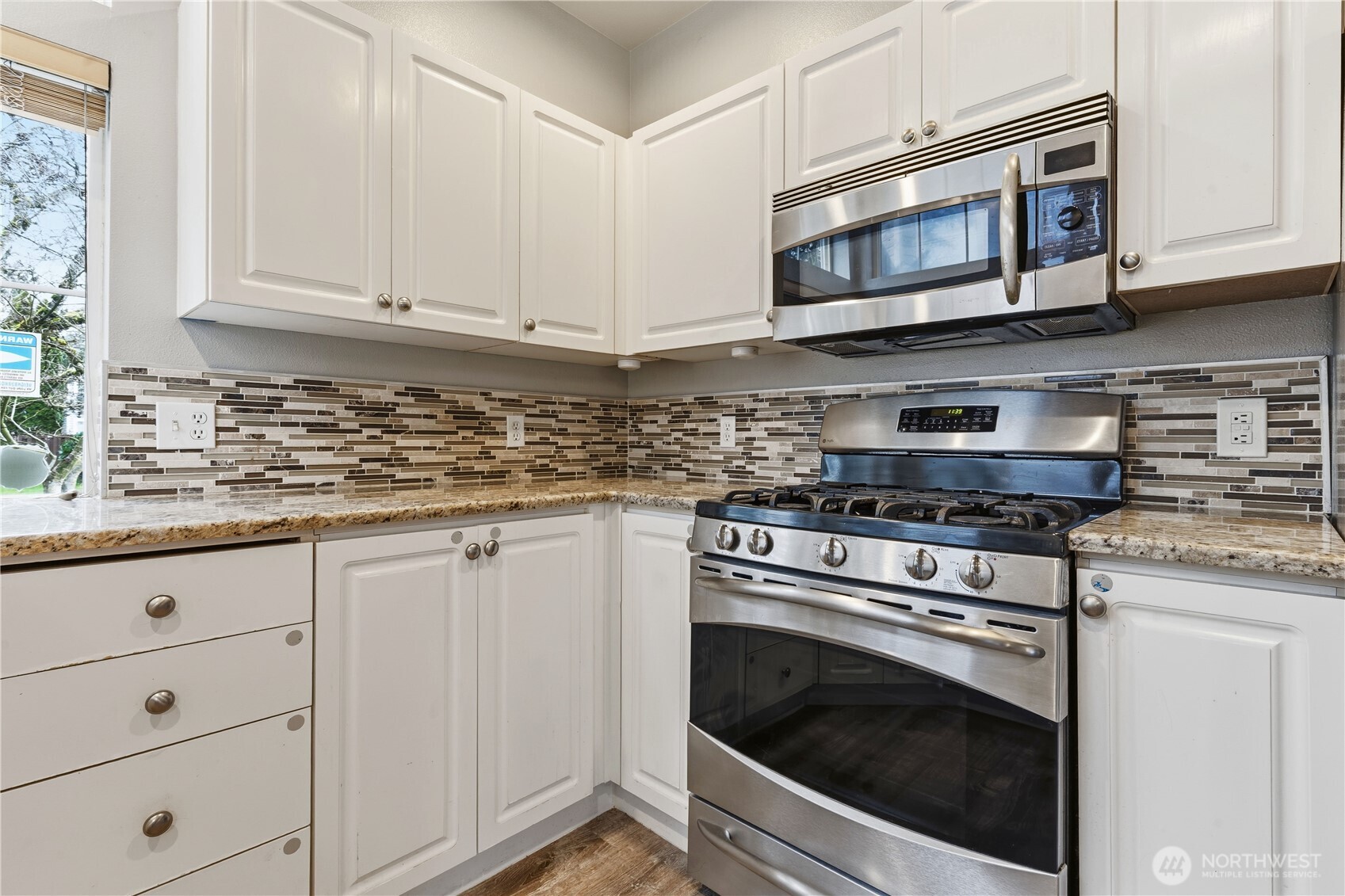 5624 South 233rd Street, Unit 41 Kent, WA 98032 - Photo 15 of 37 a kitchen with granite countertop white cabinets stainless steel appliances and a sink