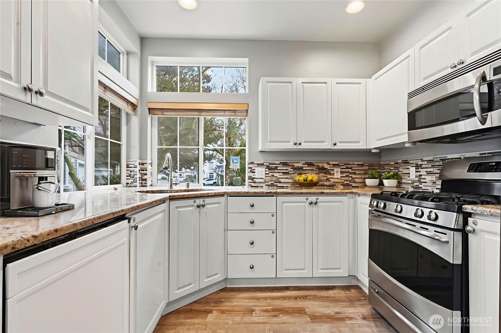5624 South 233rd Street, Unit 41 Kent, WA 98032 - Photo 4 of 37 a kitchen with stainless steel appliances granite countertop a stove a sink and a microwave