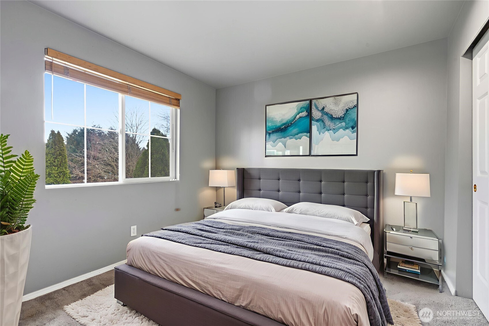 5624 South 233rd Street, Unit 41 Kent, WA 98032 - Photo 10 of 37 a bedroom with a bed and a painting on the wall