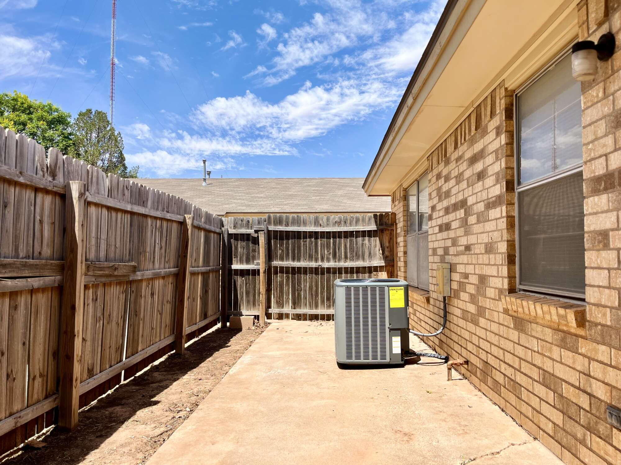 2308 74th Street, Unit B3 Lubbock, TX 79423 - Photo 15 of 18 a view of a balcony with large trees and wooden fence