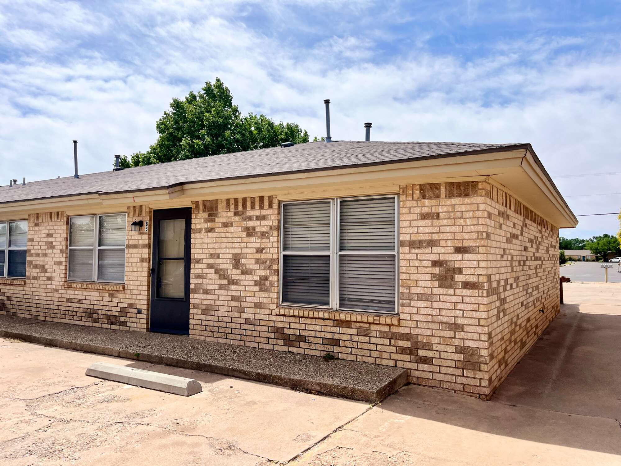 2308 74th Street, Unit B3 Lubbock, TX 79423 - Photo 2 of 18 a front view of a house with a yard