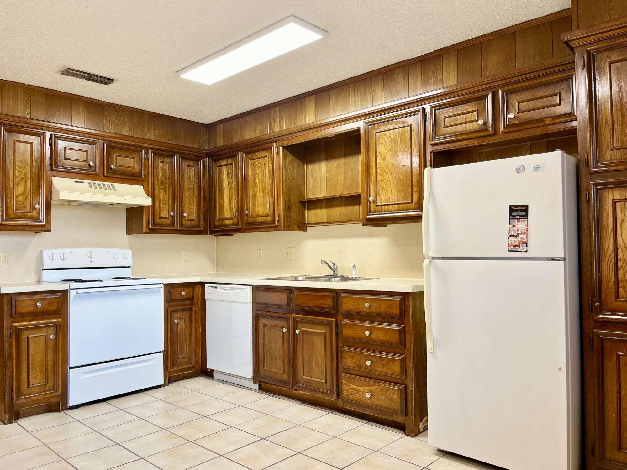 2308 74th Street, Unit B3 Lubbock, TX 79423 - Photo 7 of 18 a kitchen with stainless steel appliances granite countertop a refrigerator and a stove
