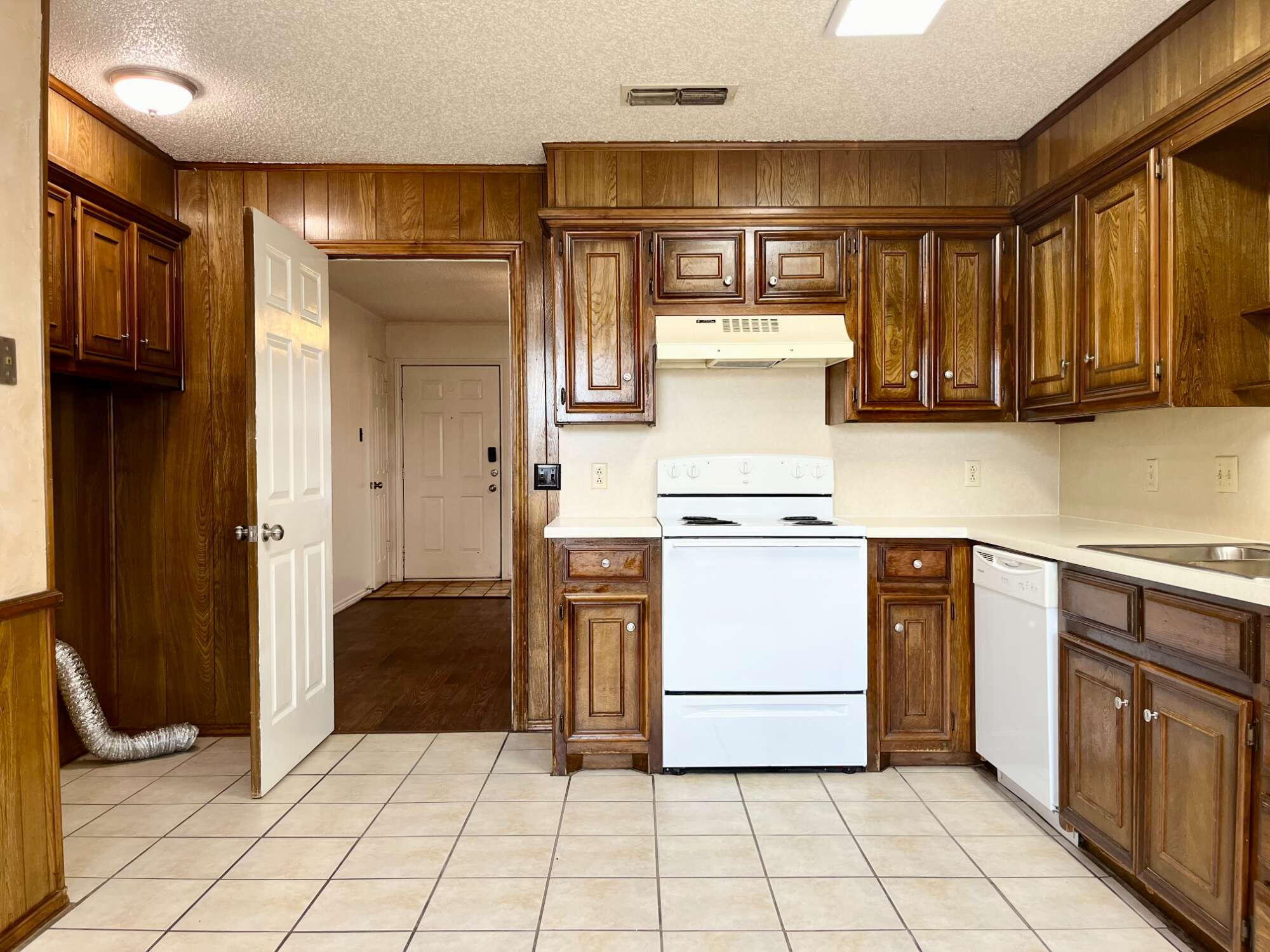 2308 74th Street, Unit B3 Lubbock, TX 79423 - Photo 8 of 18 a kitchen with a refrigerator a stove top oven and cabinets