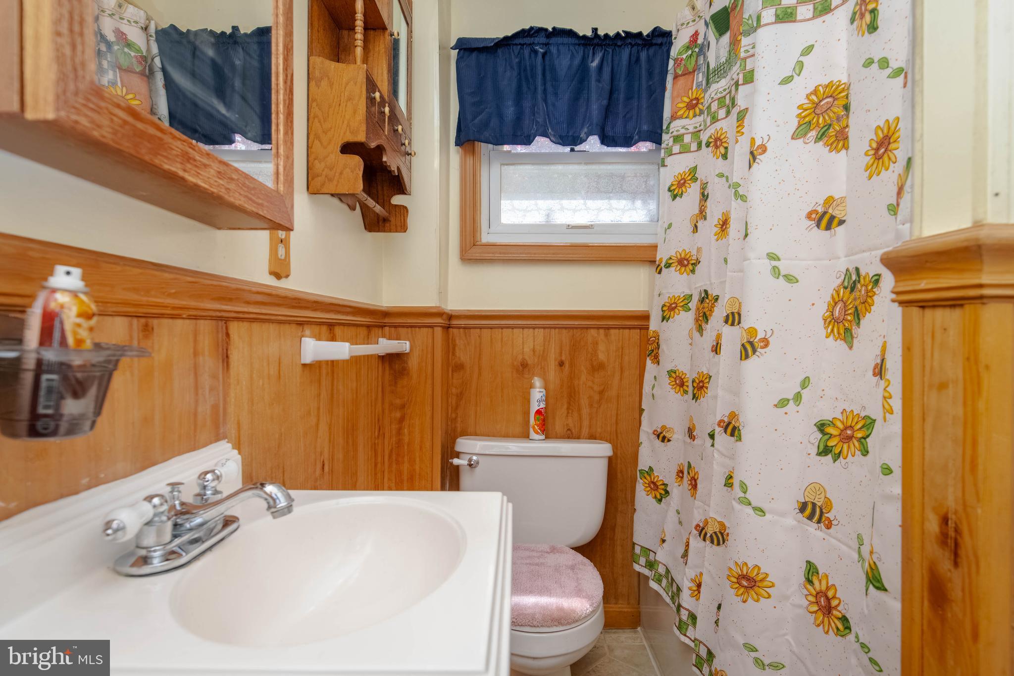 318 Lorraine Avenue Baltimore, MD 21221 - Photo 12 of 27 a white toilet sitting next to a bathroom sink