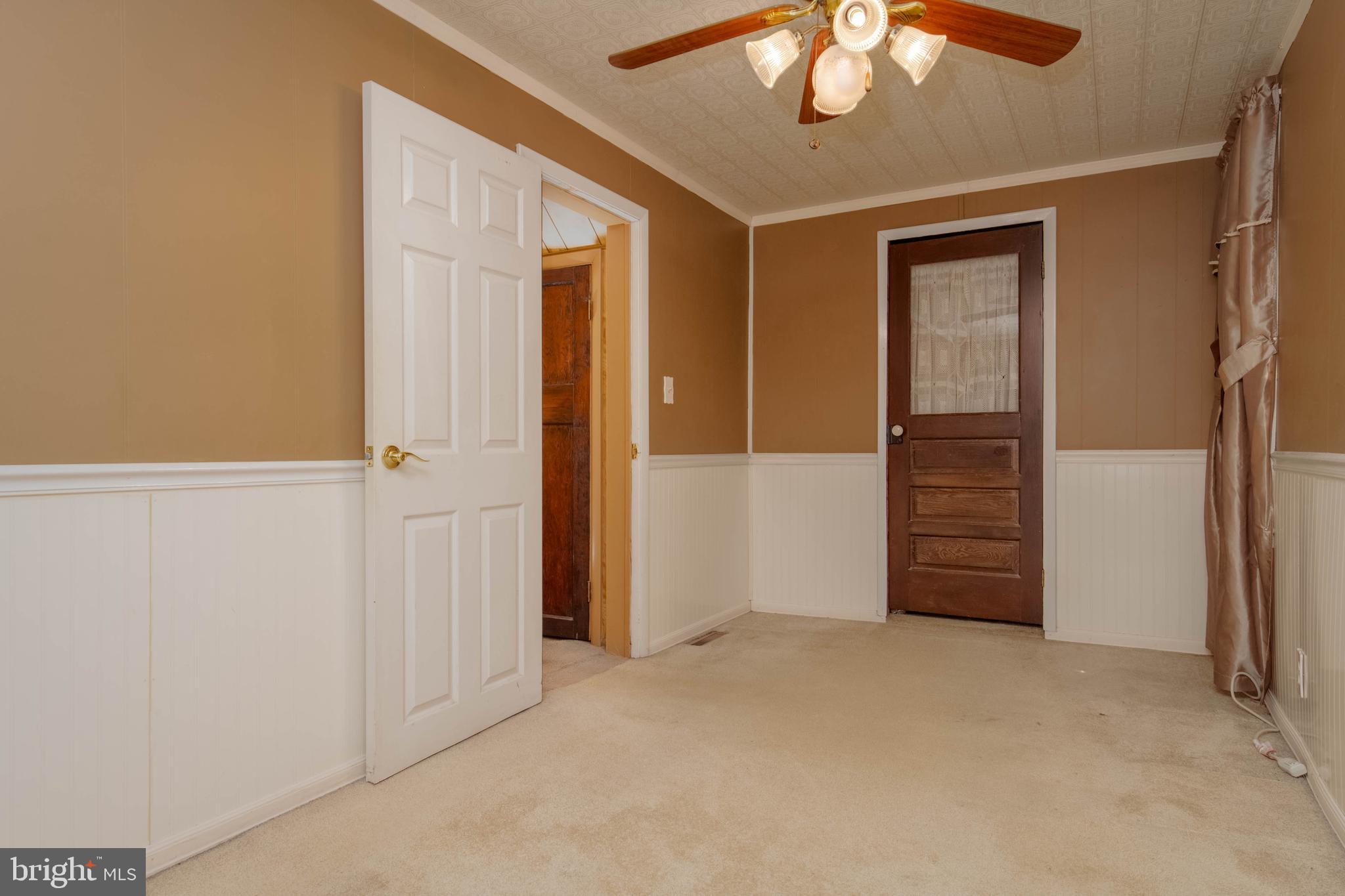 318 Lorraine Avenue Baltimore, MD 21221 - Photo 13 of 27 an empty room with closet and chandelier fan