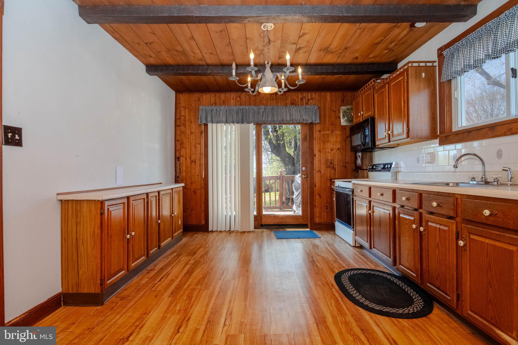318 Lorraine Avenue Baltimore, MD 21221 - Photo 8 of 27 a kitchen with wooden floors and sink