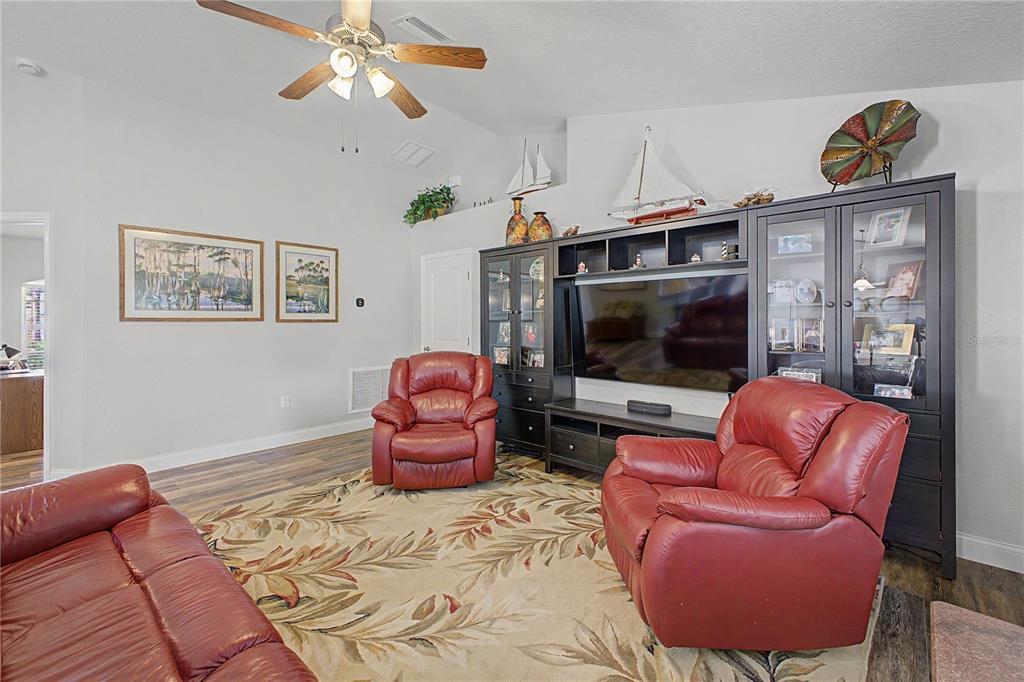 11213 Flock Avenue Weeki Wachee, FL 34613 - Photo 17 of 46 a living room with furniture a flat screen tv and a window