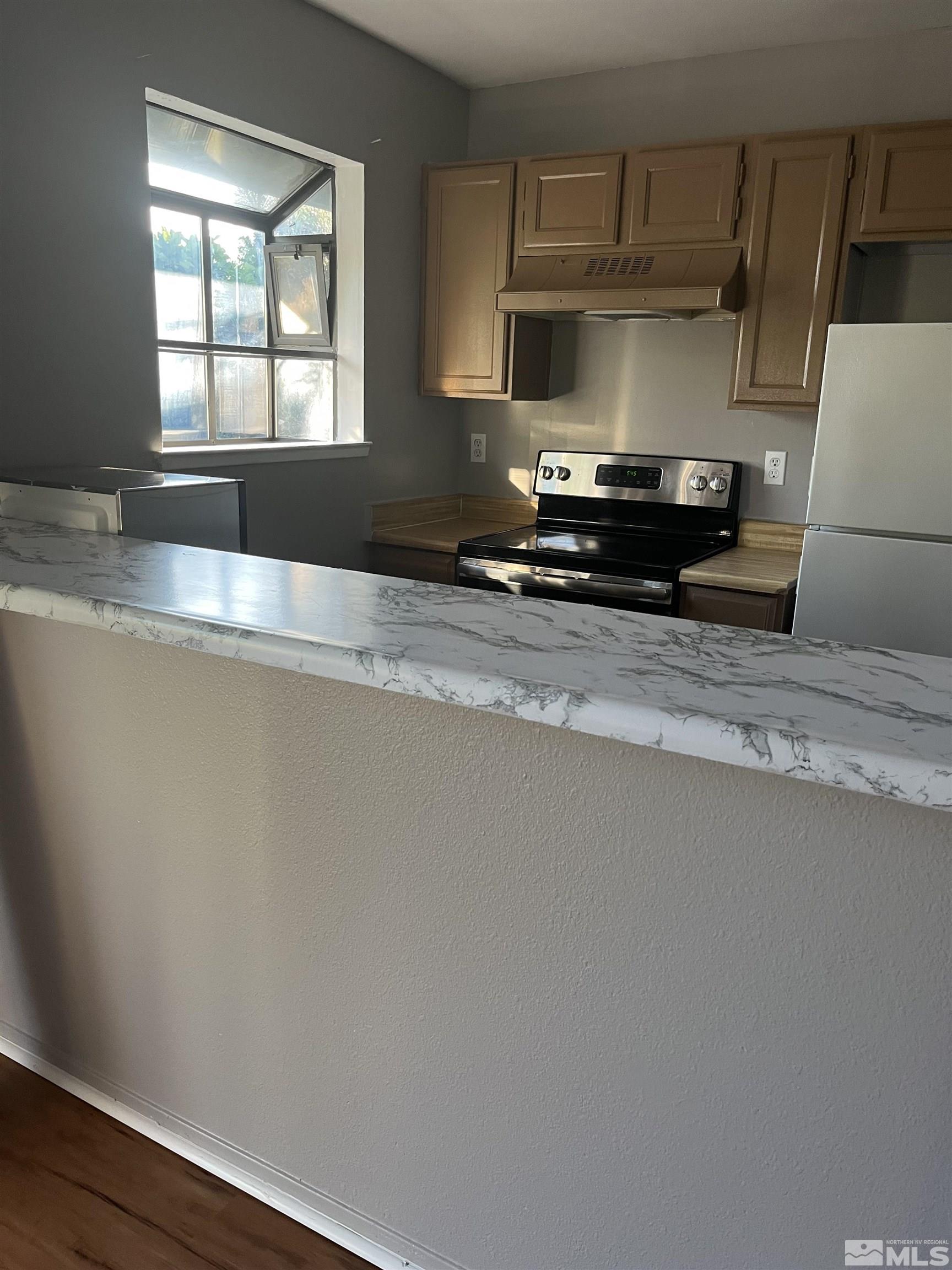 2197 Kietzke Lane, Unit E Reno, NV 89502 - Photo 2 of 7 a kitchen with a stove and a refrigerator