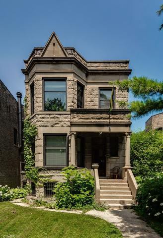 2618 West Logan Boulevard, Unit 1 Chicago, IL 60647 - Photo 1 of 1 front view of a house with a small yard