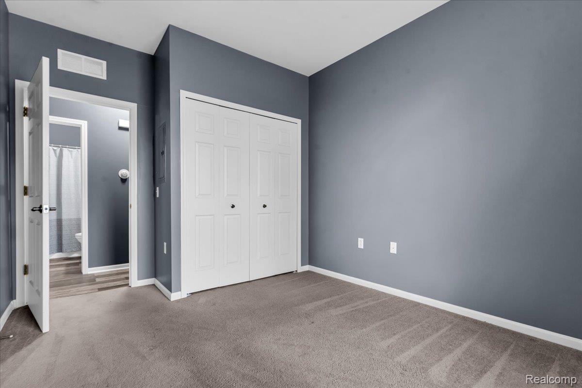 1150 Rial Lake Drive Howell, MI 48843 - Photo 13 of 24 Wall-to-wall carpeting with painted walls and white trim