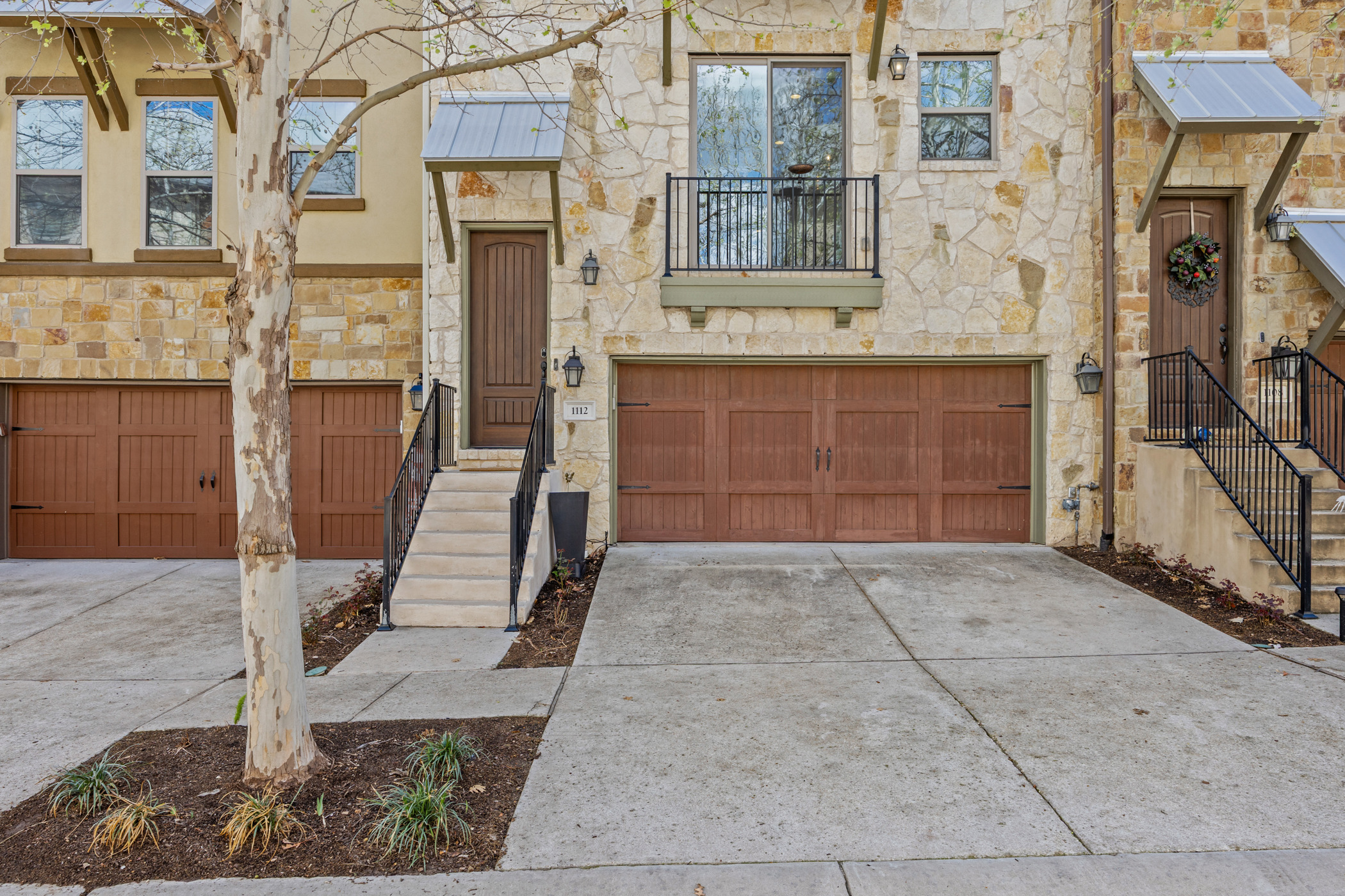 1112 Highknoll Lane Georgetown, TX 78628 - Photo 2 of 40 Texas Brownstone, private entry, and attached two-car garage in the walkable Rivery Park community.