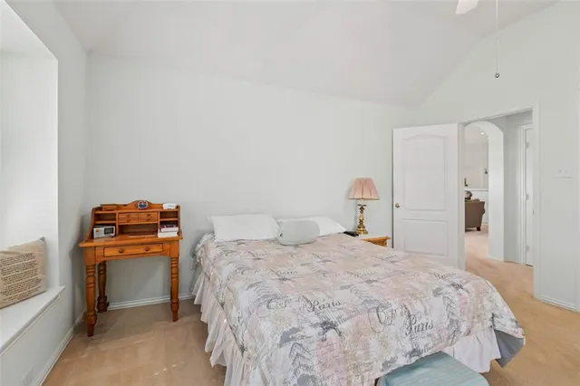 a bedroom with a bed and a lamp