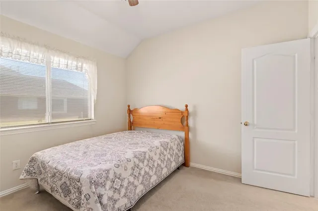 a bedroom with a bed and window