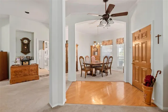 a view of a livingroom with furniture and a table chairs