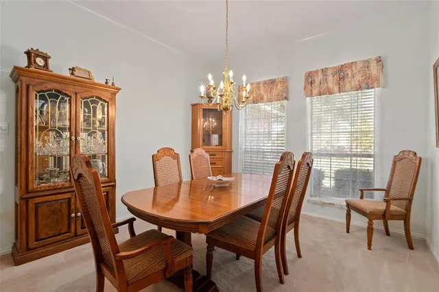 a view of a dining room with furniture and chandelier
