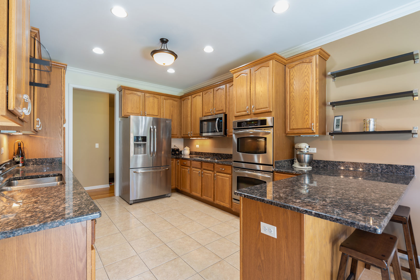 14 Winthrop New Road Sugar Grove, IL 60554 - Photo 8 of 25 a kitchen with stainless steel appliances granite countertop a stove refrigerator sink and microwave