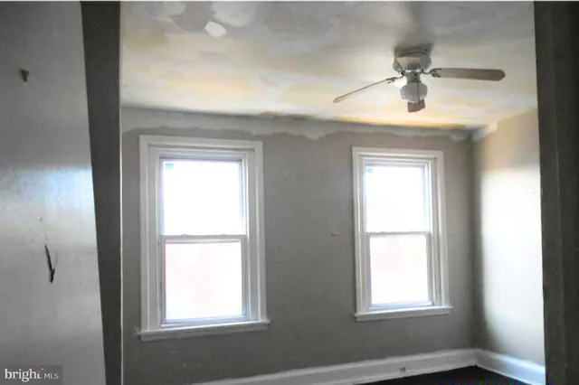 an empty room with windows and closet