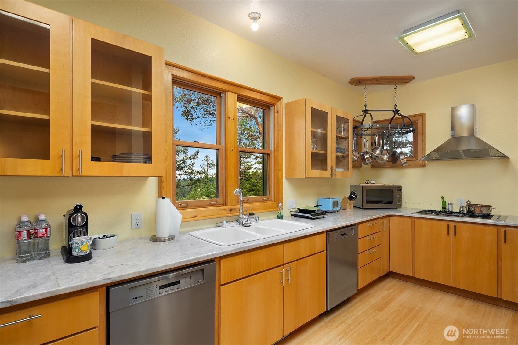 223 Blanc Road Orcas Island, WA 98245 - Photo 16 of 40 a kitchen with stainless steel appliances granite countertop a sink a stove and wooden cabinets