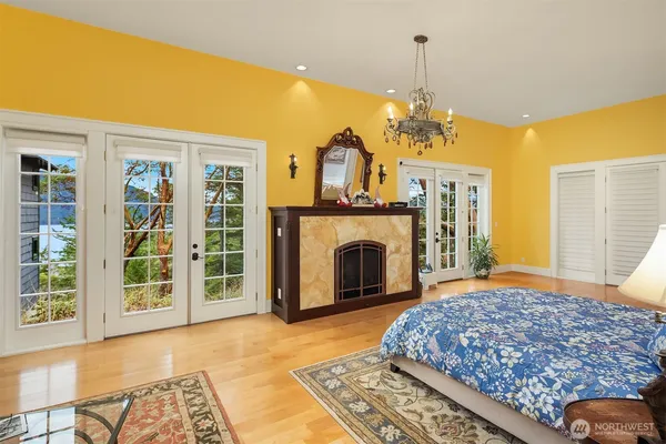 a bedroom with a bed and a fireplace
