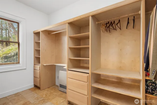 a view of walk in closet with empty racks