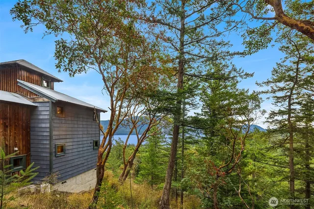 an aerial view of a house with swimming pool and porch