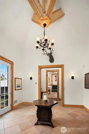 a dining room with fireplace and chandelier