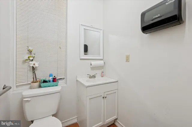 a bathroom with a sink toilet and a mirror