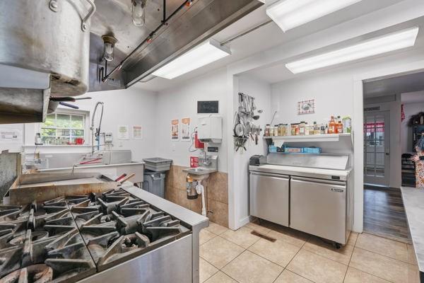 300 Main Street Volant, PA 16156 - Photo 12 of 31 a kitchen with stainless steel appliances granite countertop a stove and a sink