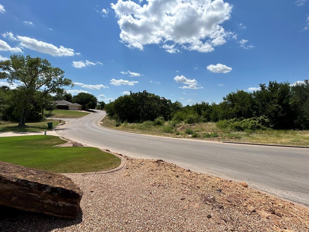 a view of a yard with swimming pool