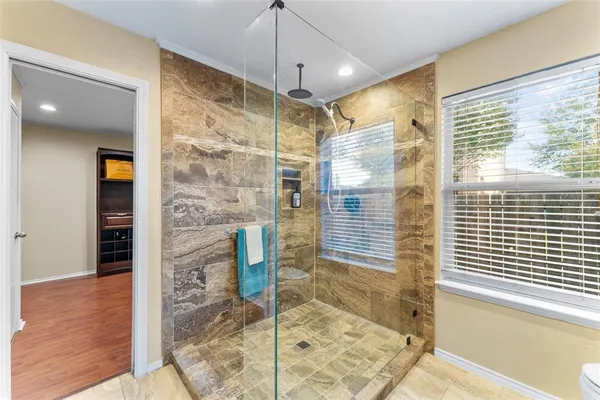 a bathroom with a glass shower door