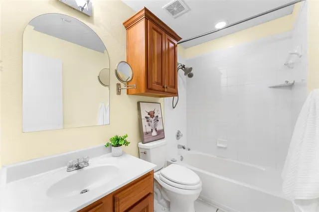 a view of a big room with wooden floor and windows