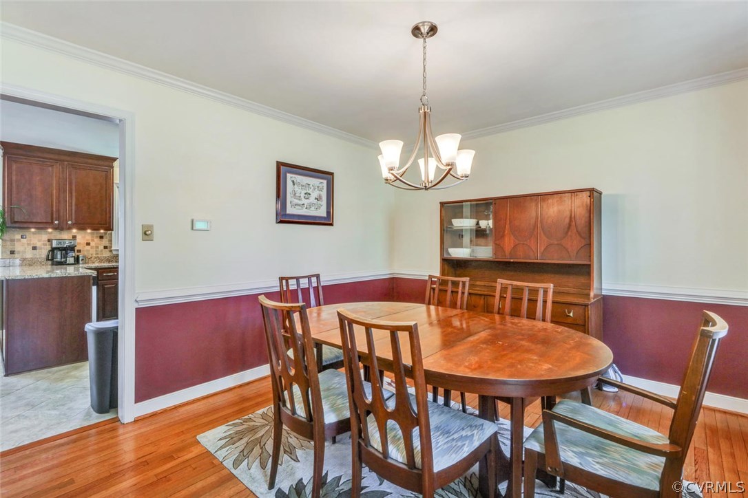 13400 Lady Ashley Road Midlothian, VA 23114 - Photo 13 of 31 a view of a dining room with furniture a chandelier and wooden floor