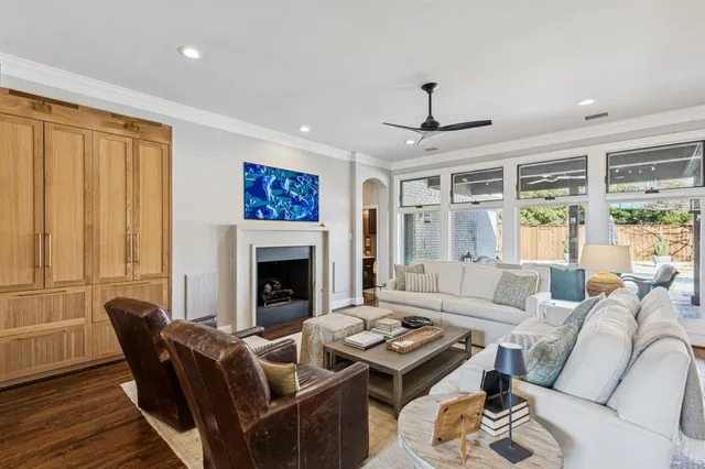 a living room with furniture a fireplace and a table