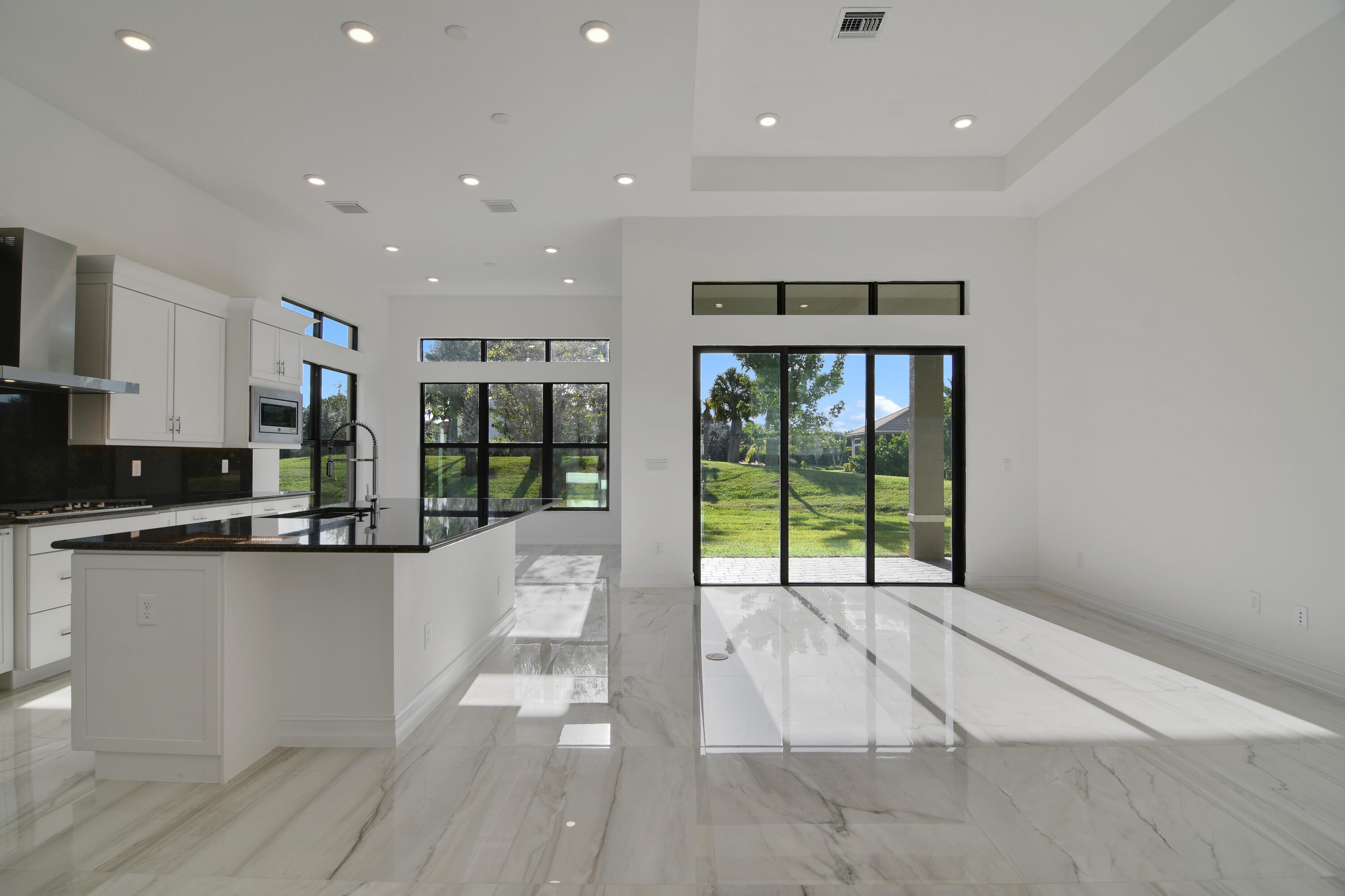 8827 Leon Circle, Unit 286 Parkland, FL 33076 - Photo 11 of 34 a open kitchen with stainless steel appliances granite countertop a refrigerator a sink and a large window