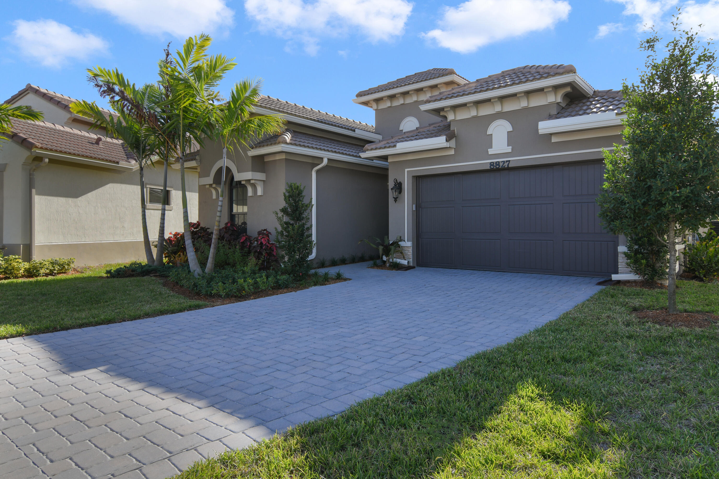 8827 Leon Circle, Unit 286 Parkland, FL 33076 - Photo 2 of 34 a front view of a house with a yard