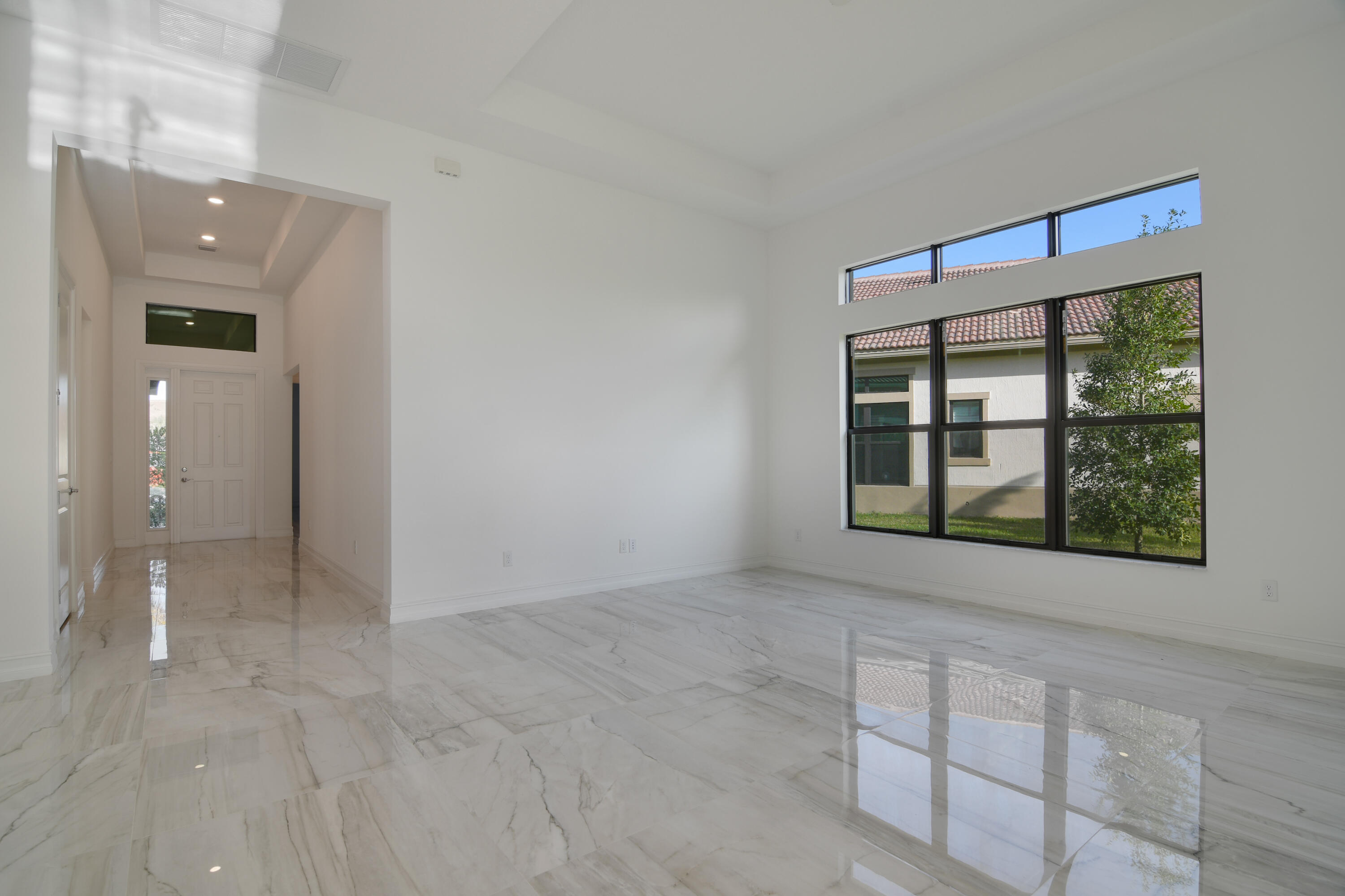 8827 Leon Circle, Unit 286 Parkland, FL 33076 - Photo 22 of 34 an empty room with windows and entrance