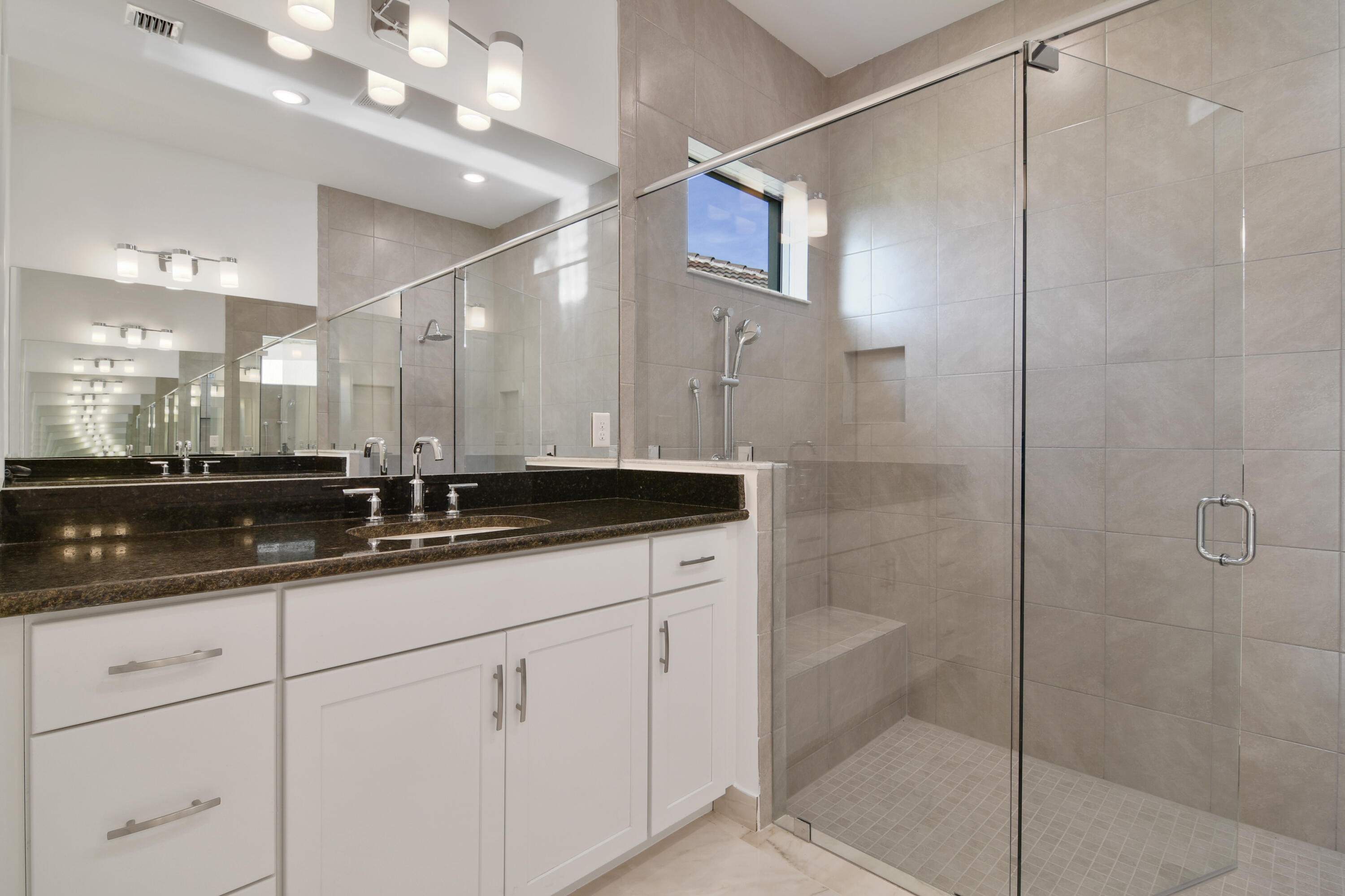 8827 Leon Circle, Unit 286 Parkland, FL 33076 - Photo 27 of 34 a bathroom with a shower sink and mirror