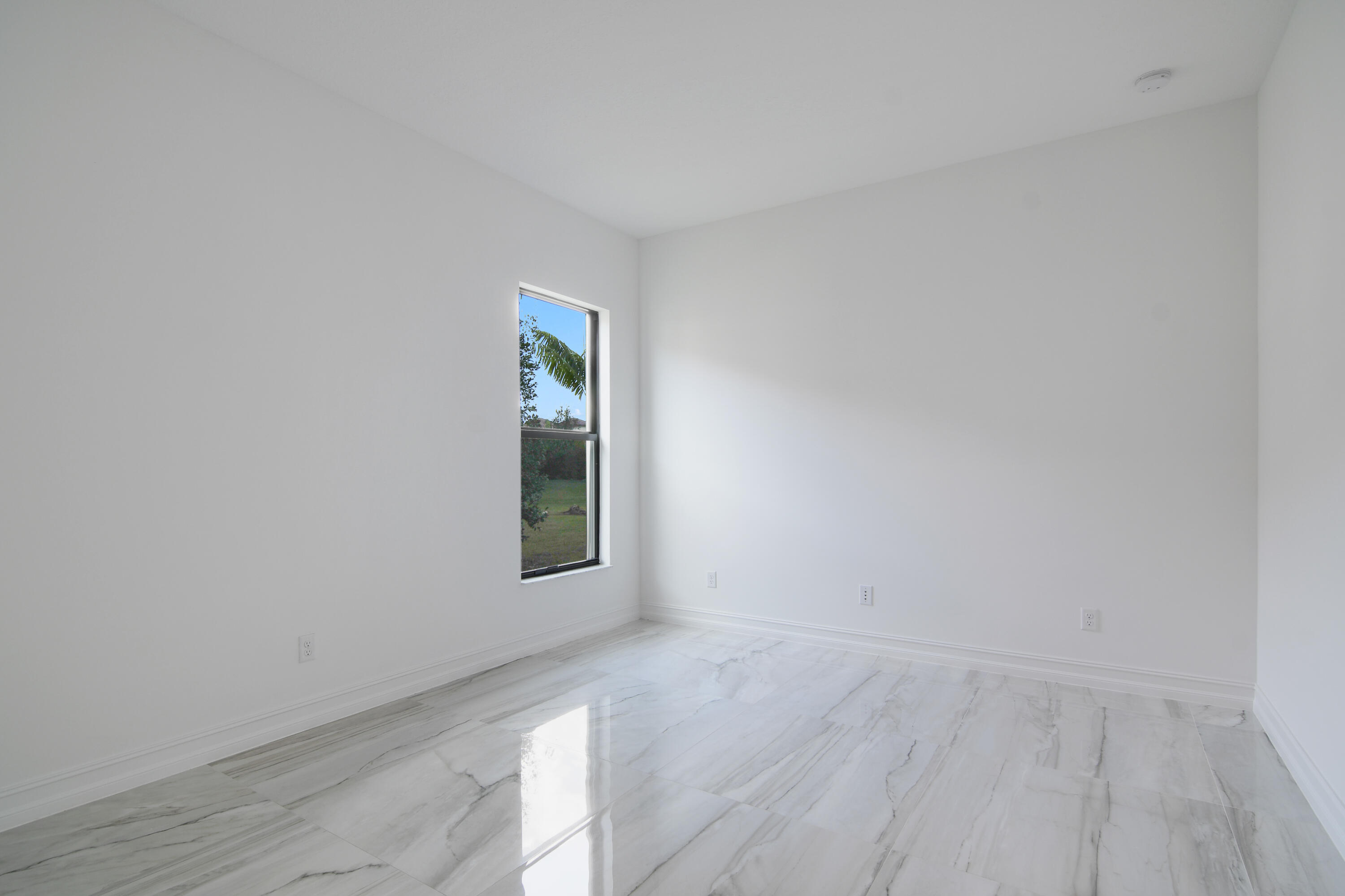 8827 Leon Circle, Unit 286 Parkland, FL 33076 - Photo 29 of 34 a view of an empty room with wooden floor and a window