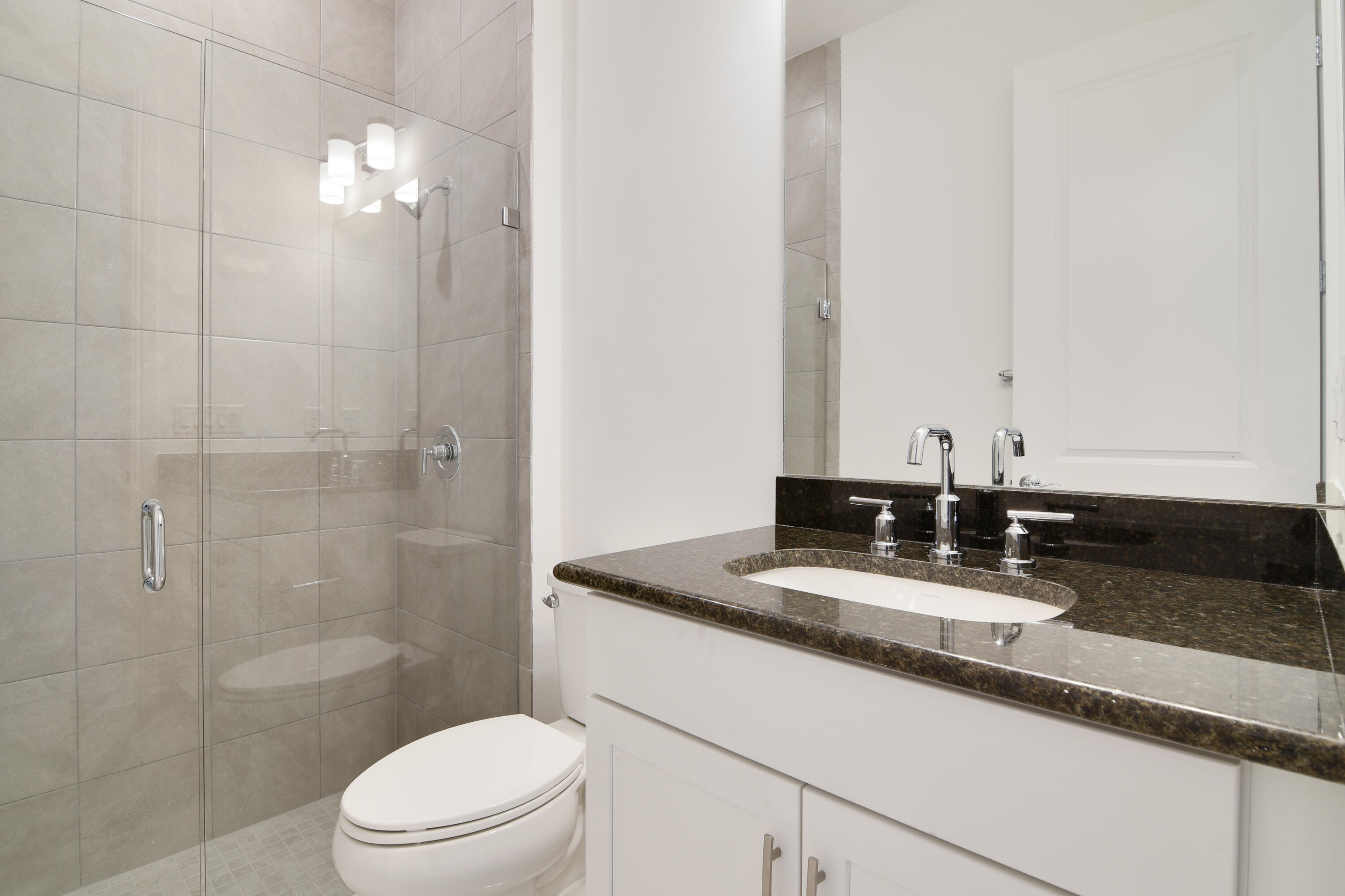 8827 Leon Circle, Unit 286 Parkland, FL 33076 - Photo 31 of 34 a bathroom with a granite countertop sink a toilet and shower
